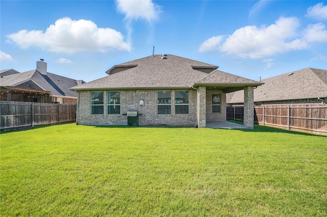 1306 Torrington Ln, Forney, TX 75126 - rear view of property featuring a shingled roof, brick siding, and a patio
