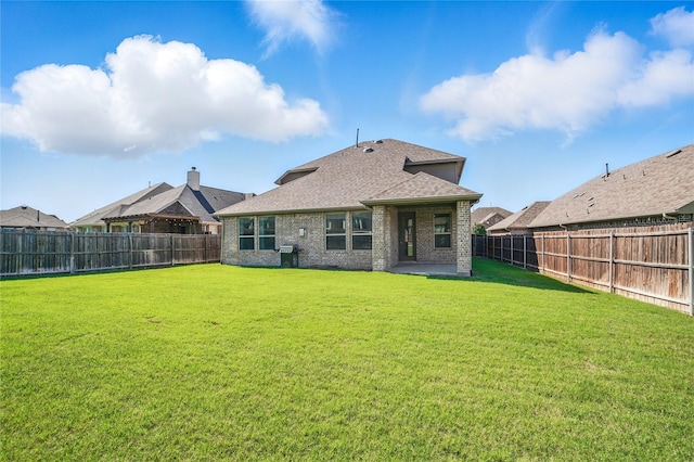 1306 Torrington Ln, Forney, TX 75126 - rear view of property featuring roof with shingles, brick siding, and a patio area