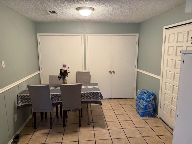 501 Towne House Ln, Richardson, TX 75081 - dining space featuring a textured ceiling and light tile patterned floors