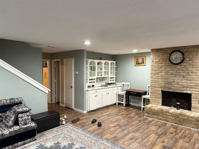 501 Towne House Ln, Richardson, TX 75081 - living area with dark wood-type flooring, a fireplace, recessed lighting, and baseboards