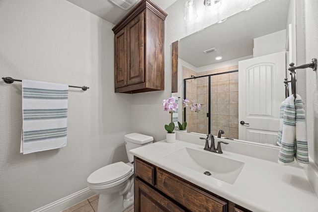 1412 Siena Ln, Rockwall, TX 75032 - full bathroom featuring toilet, vanity, a tile shower, tile patterned flooring, and baseboards