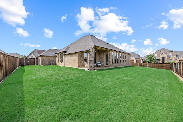 1412 Siena Ln, Rockwall, TX 75032 - rear view of house featuring brick siding, a shingled roof, and a patio area