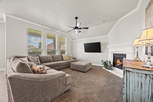 1412 Siena Ln, Rockwall, TX 75032 - carpeted living room with lofted ceiling, a ceiling fan, crown molding, a glass covered fireplace, and baseboards
