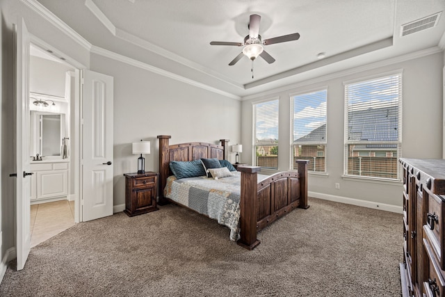 1412 Siena Ln, Rockwall, TX 75032 - bedroom with a raised ceiling, light colored carpet, baseboards, ornamental molding, and ensuite bath