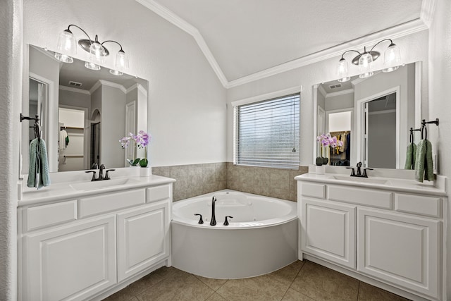 1412 Siena Ln, Rockwall, TX 75032 - bathroom with ornamental molding, tile patterned floors, two vanities, vaulted ceiling, and a bath
