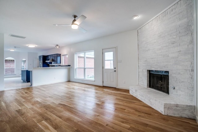 1467 Norfolk Ct, Allen, TX 75002 - unfurnished living room with a fireplace, wood finished floors, a ceiling fan, and baseboards