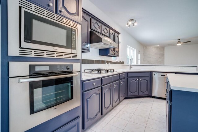 1467 Norfolk Ct, Allen, TX 75002 - kitchen with stainless steel appliances, a sink, light countertops, a ceiling fan, and a peninsula