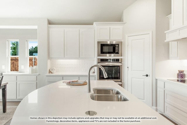 2503 Jennifer Ln, Mansfield, TX 76063 - kitchen with oven, built in microwave, light countertops, white cabinetry, and a sink