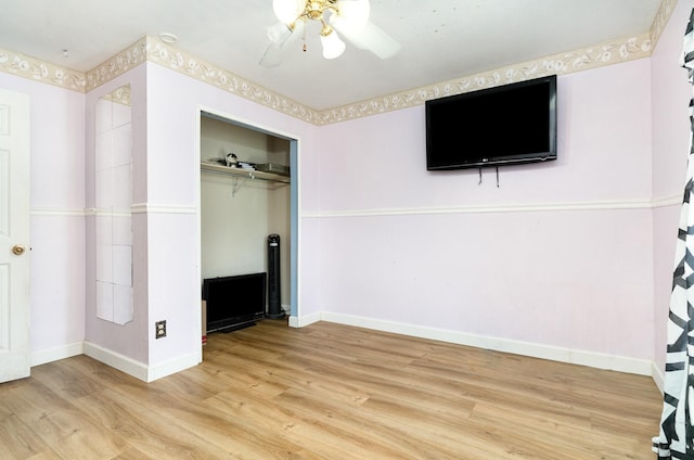 1502 Santa Fe Trl, Grand Prairie, TX 75052 - unfurnished bedroom featuring light wood-style floors, baseboards, a closet, and a ceiling fan