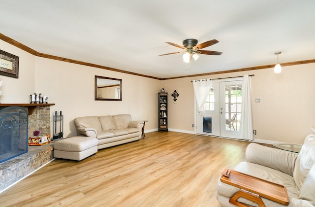 1502 Santa Fe Trl, Grand Prairie, TX 75052 - living area featuring a fireplace, a ceiling fan, wood finished floors, ornamental molding, and baseboards