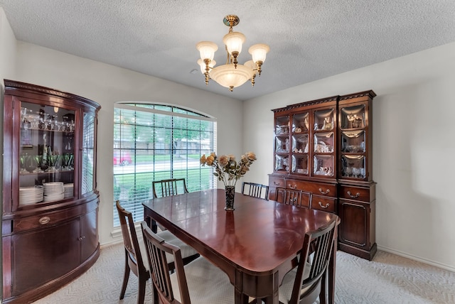 227 Meadowlark Ln, Duncanville, TX 75137 - dining space featuring a chandelier, light colored carpet, a textured ceiling, and baseboards