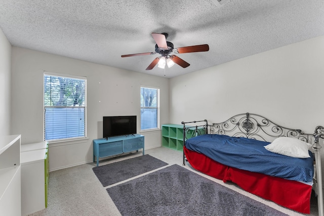 227 Meadowlark Ln, Duncanville, TX 75137 - bedroom with multiple windows, carpet, a textured ceiling, and a ceiling fan