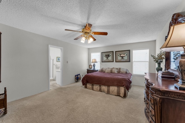 227 Meadowlark Ln, Duncanville, TX 75137 - bedroom featuring light colored carpet, connected bathroom, ceiling fan, a textured ceiling, and baseboards