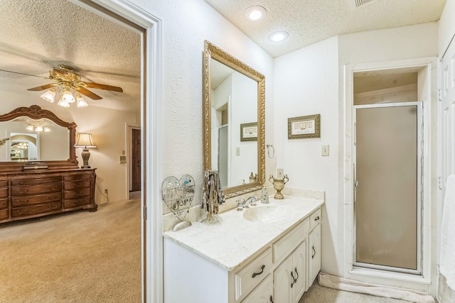 227 Meadowlark Ln, Duncanville, TX 75137 - bathroom with a textured ceiling, vanity, a shower stall, and a ceiling fan