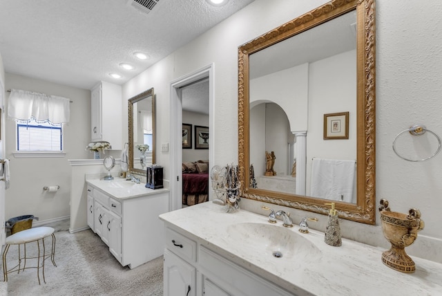 227 Meadowlark Ln, Duncanville, TX 75137 - ensuite bathroom with a textured ceiling, two vanities, and recessed lighting