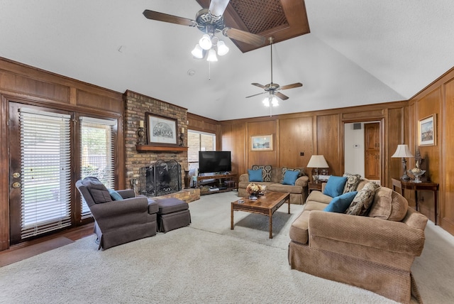 227 Meadowlark Ln, Duncanville, TX 75137 - carpeted living area featuring a ceiling fan, wood walls, a brick fireplace, and high vaulted ceiling