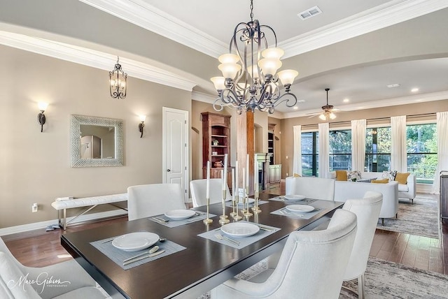 1010 Toledano Cir, Shreveport, LA 71106 - dining area with a chandelier, wood finished floors, ornamental molding, a ceiling fan, and baseboards
