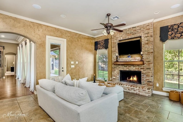 1010 Toledano Cir, Shreveport, LA 71106 - living area featuring arched walkways, ceiling fan, a brick fireplace, baseboards, and ornamental molding