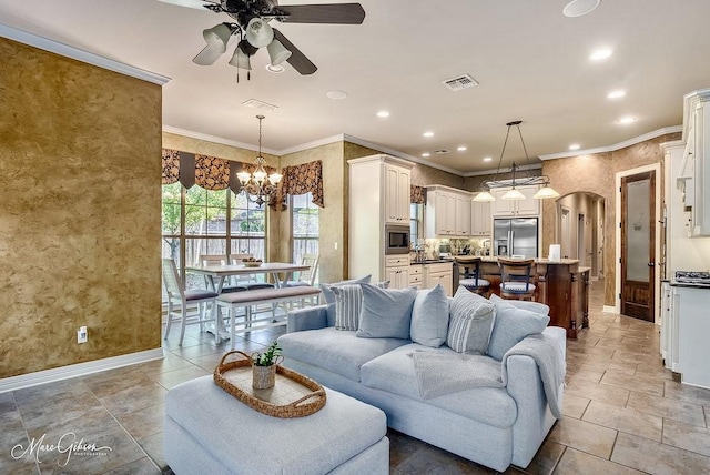 1010 Toledano Cir, Shreveport, LA 71106 - living room featuring ceiling fan, baseboards, crown molding, arched walkways, and a chandelier