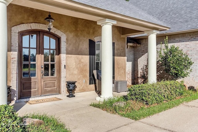 1010 Toledano Cir, Shreveport, LA 71106 - doorway to property with french doors, a shingled roof, brick siding, and stucco siding