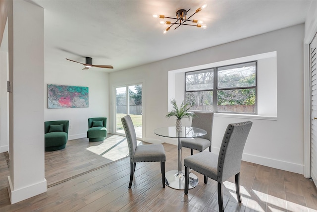 5607 Emrose Cir, Dallas, TX 75227 - dining area with baseboards, a chandelier, wood finished floors, and ceiling fan