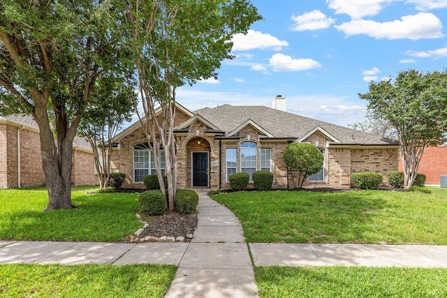 1408 Tartan Dr, Allen, TX 75013 - traditional-style house featuring a front lawn, a chimney, brick siding, and roof with shingles