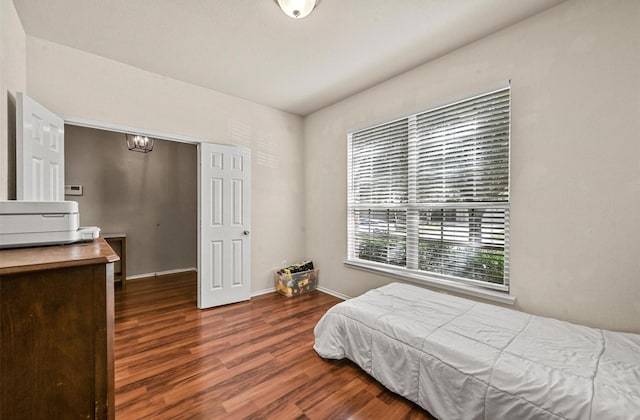 405 Cypress Hill Dr, Mckinney, TX 75071 - bedroom with wood finished floors, baseboards, and a chandelier