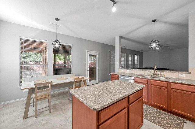 405 Cypress Hill Dr, Mckinney, TX 75071 - kitchen with dishwasher, a sink, a kitchen island, ceiling fan, and brown cabinetry