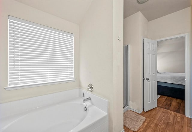 405 Cypress Hill Dr, Mckinney, TX 75071 - ensuite bathroom with wood finished floors, a garden tub, a shower stall, plenty of natural light, and vaulted ceiling