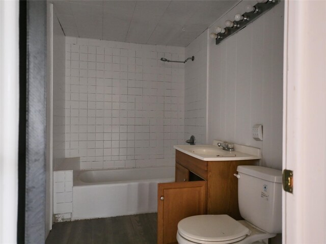 927 London St, Vernon, TX 76384 - bathroom with toilet, tub / shower combination, vanity, and wood finished floors