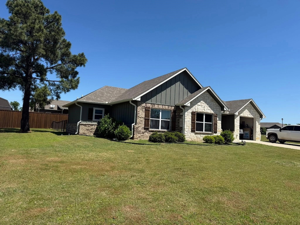 207 Mill St, Emory, TX 75440 - craftsman inspired home featuring board and batten siding, an attached garage, stone siding, and driveway