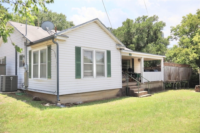 307 Cedar St, Palo Pinto, TX 76484 - back of property with cooling unit, a lawn, and a porch