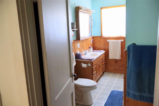 307 Cedar St, Palo Pinto, TX 76484 - bathroom featuring wainscoting, vanity, wood walls, and toilet