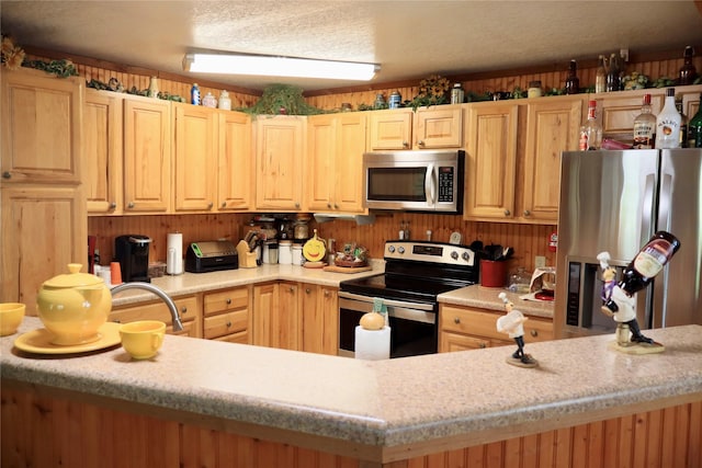 307 Cedar St, Palo Pinto, TX 76484 - kitchen featuring appliances with stainless steel finishes, light countertops, and light brown cabinetry