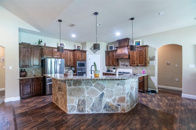665 Amanda Lee, Combine, TX 75159 - kitchen with appliances with stainless steel finishes, arched walkways, a spacious island, decorative backsplash, and recessed lighting