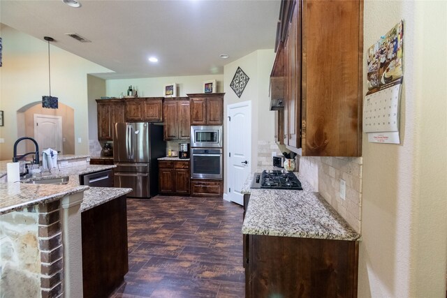 665 Amanda Lee, Combine, TX 75159 - kitchen featuring appliances with stainless steel finishes, a sink, dark wood-style floors, decorative backsplash, and light stone countertops