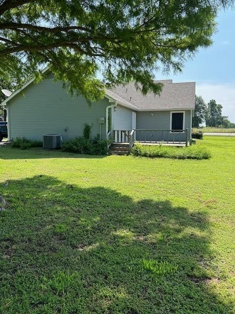 5500 Vz County Road 3415, Wills Point, TX 75169 - back of property with a lawn and central AC unit
