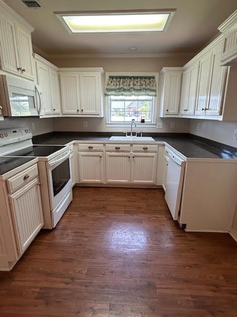5500 Vz County Road 3415, Wills Point, TX 75169 - kitchen with white appliances, a sink, dark countertops, dark wood-style floors, and ornamental molding