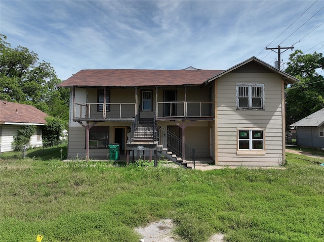 1428 Texas St, Vernon, TX 76384 - back of property with stairway, a shingled roof, and covered porch