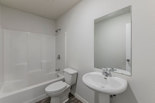 1718 Chestnut St, Abilene, TX 79602 - bathroom with wood finished floors, toilet, bathtub / shower combination, and a sink