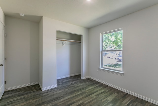 1718 Chestnut St, Abilene, TX 79602 - unfurnished bedroom featuring dark wood-style floors, baseboards, and a closet