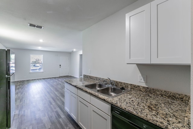 1718 Chestnut St, Abilene, TX 79602 - kitchen with a sink, black appliances, wood finished floors, white cabinetry, and open floor plan