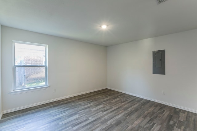 1718 Chestnut St, Abilene, TX 79602 - spare room featuring electric panel, dark wood finished floors, and baseboards