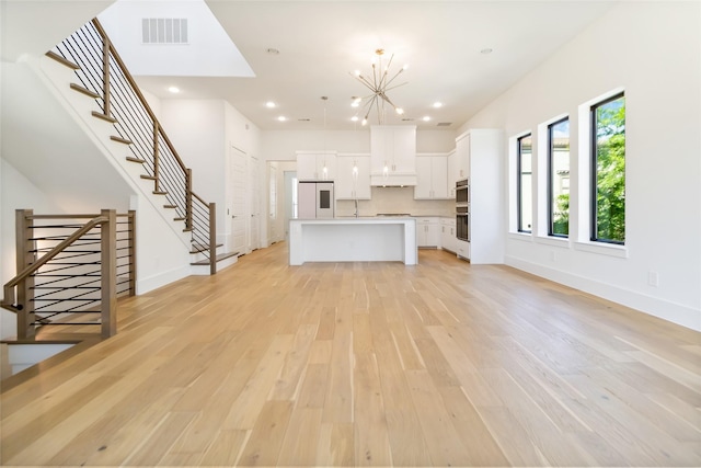 7844 Secluded Ave, Plano, TX 75024 - unfurnished living room with light wood-style flooring, a chandelier, stairway, baseboards, and recessed lighting