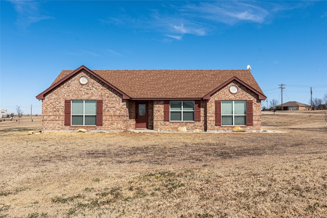 111 Ladonna Ct, Decatur, TX 76234 - ranch-style home with a shingled roof, brick siding, and a front lawn