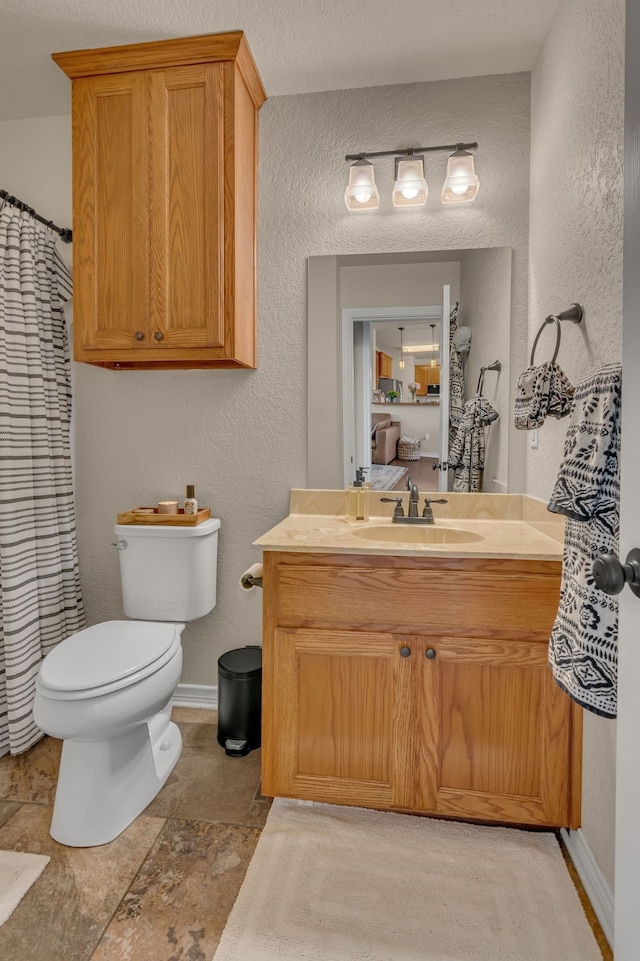 111 Ladonna Ct, Decatur, TX 76234 - full bathroom featuring vanity, toilet, a textured wall, and baseboards