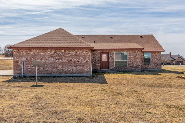 111 Ladonna Ct, Decatur, TX 76234 - rear view of house with a lawn, a shingled roof, and brick siding