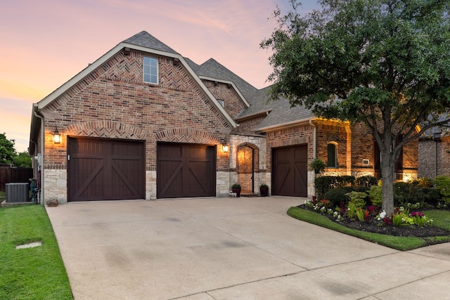 3308 Linkwood, The Colony, TX 75056 - french country inspired facade featuring a garage, central air condition unit, concrete driveway, brick siding, and stone siding