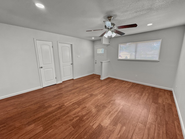 3837 Finley Rd, Irving, TX 75062 - unfurnished bedroom with wood finished floors, baseboards, recessed lighting, a ceiling fan, and a textured ceiling