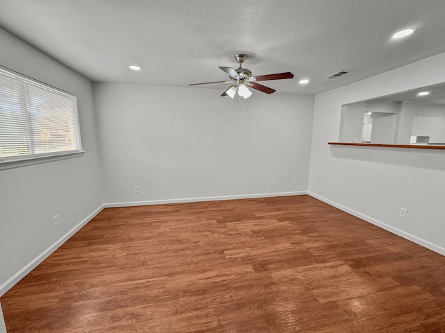 3837 Finley Rd, Irving, TX 75062 - unfurnished room featuring ceiling fan, wood finished floors, recessed lighting, baseboards, and a textured ceiling